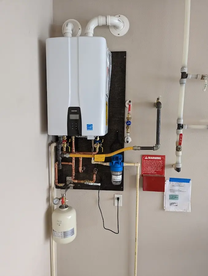 Professional plumber installing copper piping in a O'Hara home